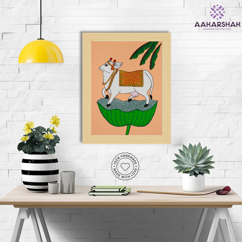 Framed artwork with cow design on a peach background-handmade pichwai painting for home decor