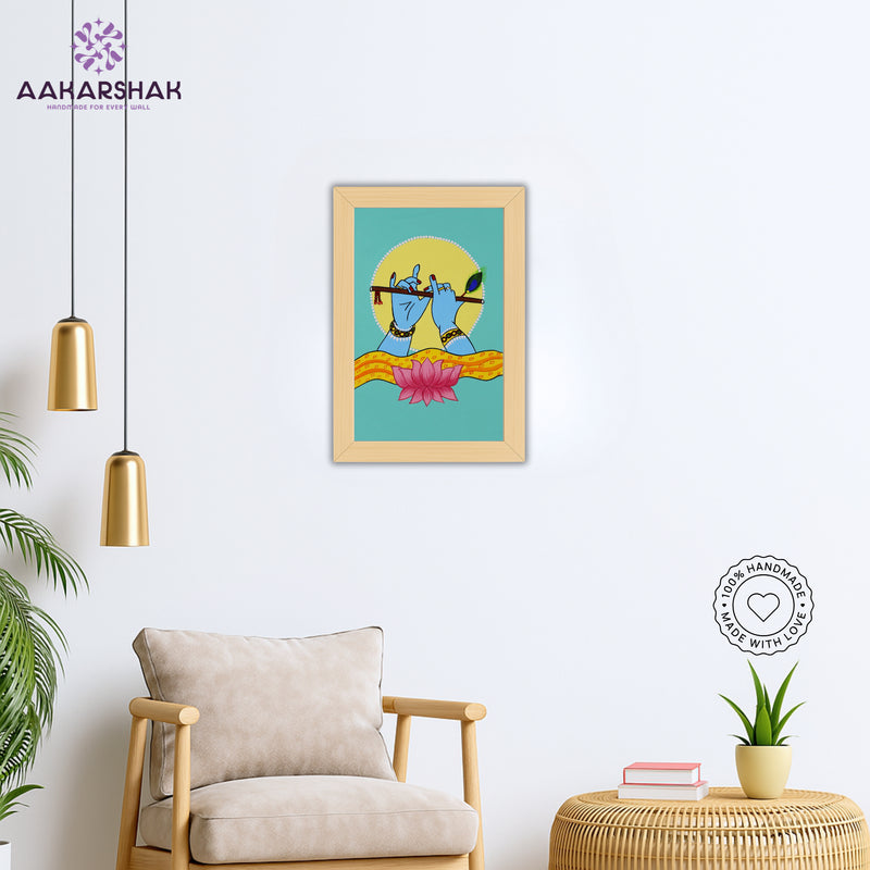 Framed artwork of hands playing a flute with a lotus-vibrant handmade krishna painting-depicting indian folk traditions