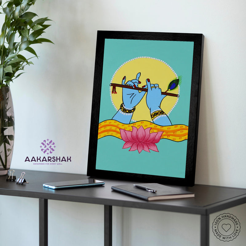 Framed artwork of hands playing a flute with a lotus-vibrant handmade krishna painting-depicting indian folk traditions