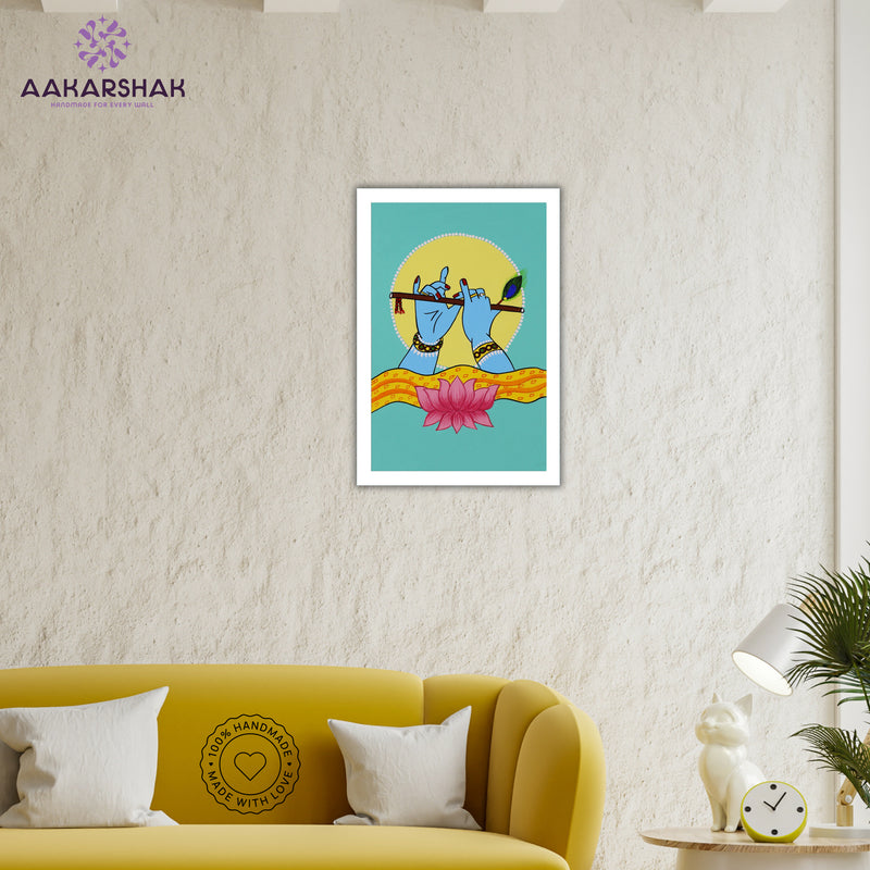Framed artwork of hands playing a flute with a lotus-vibrant handmade krishna painting-depicting indian folk traditions