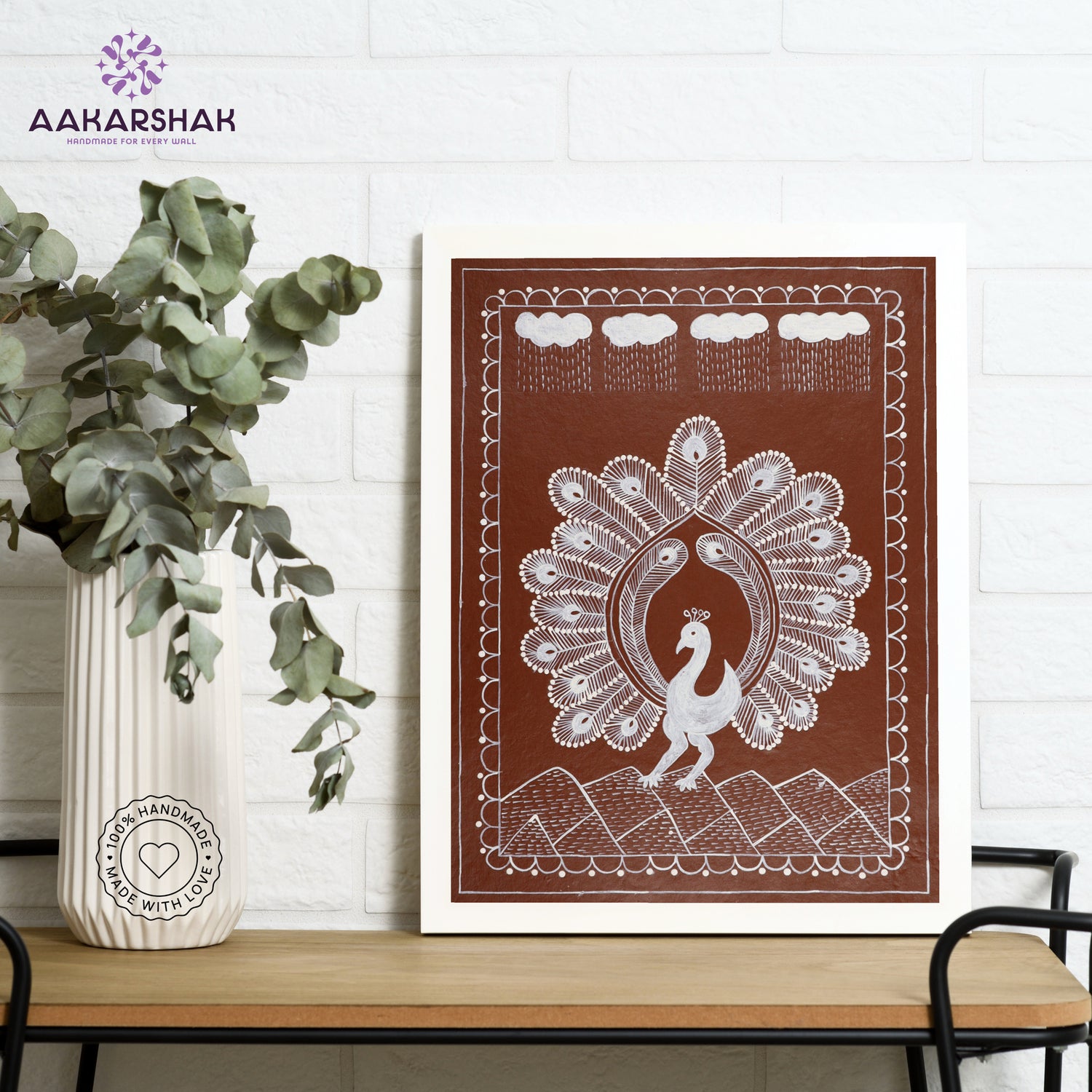 Framed artwork with white peacock design on a brown background-handmade warli painting for home decor