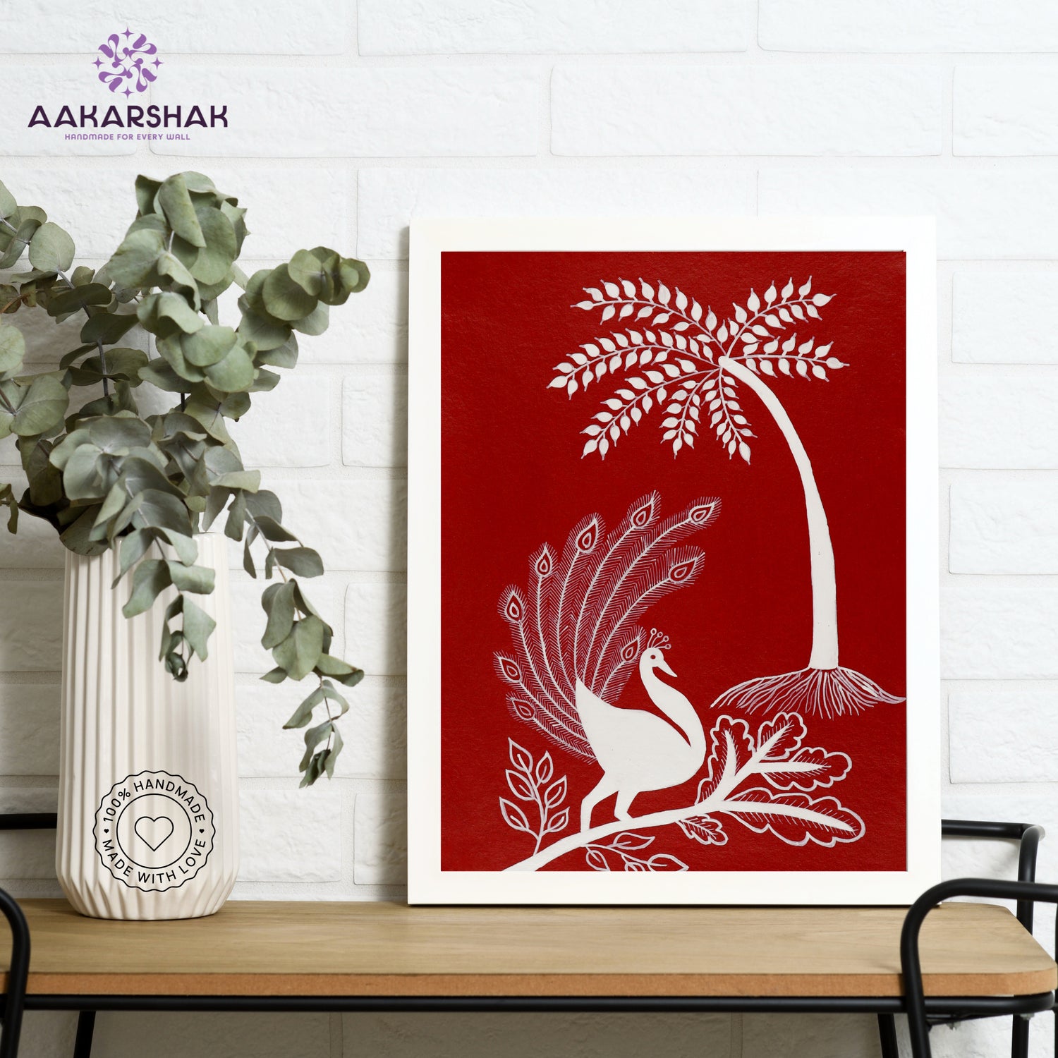 Framed artwork with white peacock design on a red background-handmade warli painting for home decor
